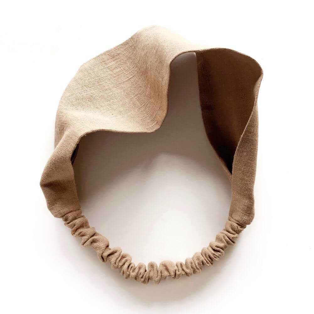 Taupe brown linen headband on a white background