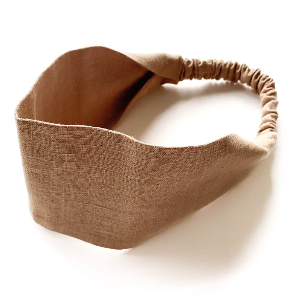 Taupe brown linen headband on a white background
