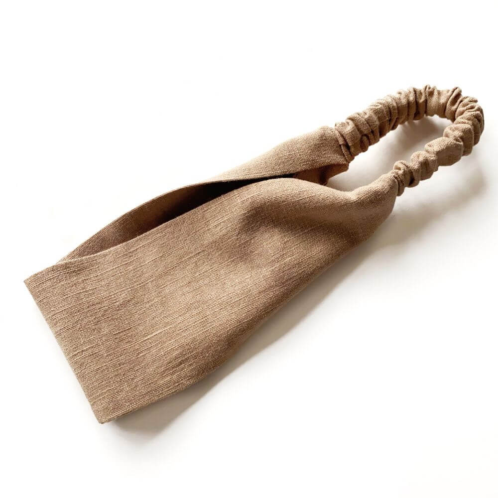 Taupe brown linen headband on a white background