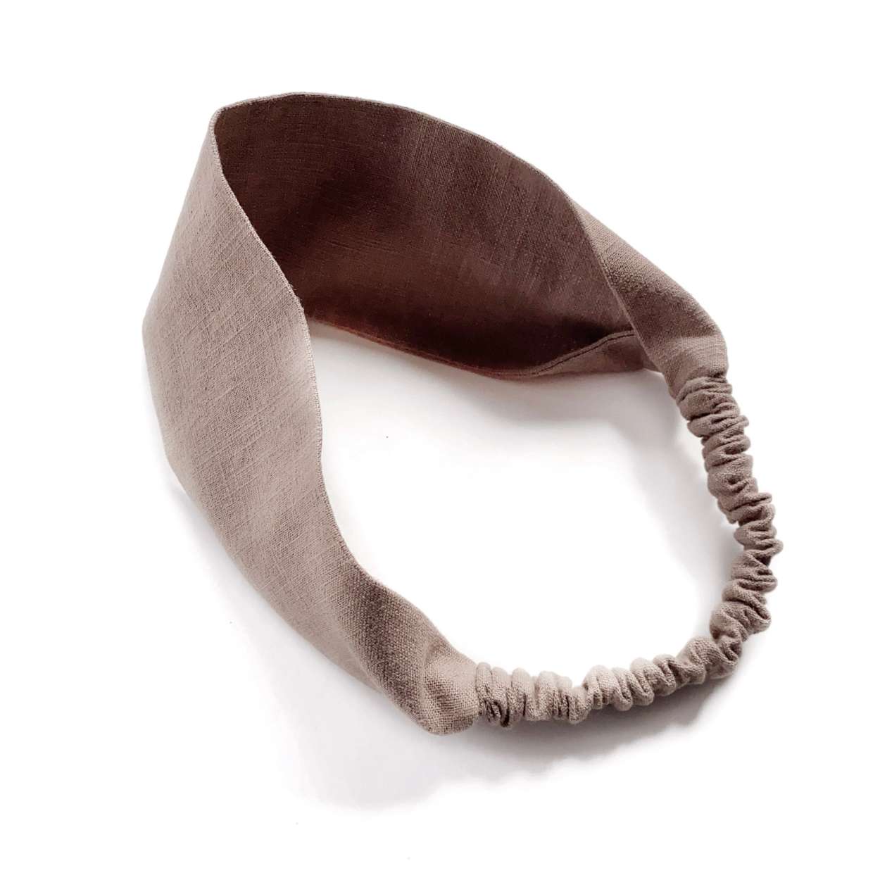 Brown linen headband on a white background