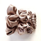Set of taupe mulberry silk satin scrunchies and hair ties on a white background