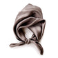 A taupe brown mulberry silk square scarf tied in a knot, displayed on a clean white background.