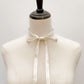 Mannequin wearing a ultra skinny ivory cream-colored mulberry silk neck tie against a plain background