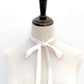 Mannequin wearing a white silk ribbon neck tie with a plain background