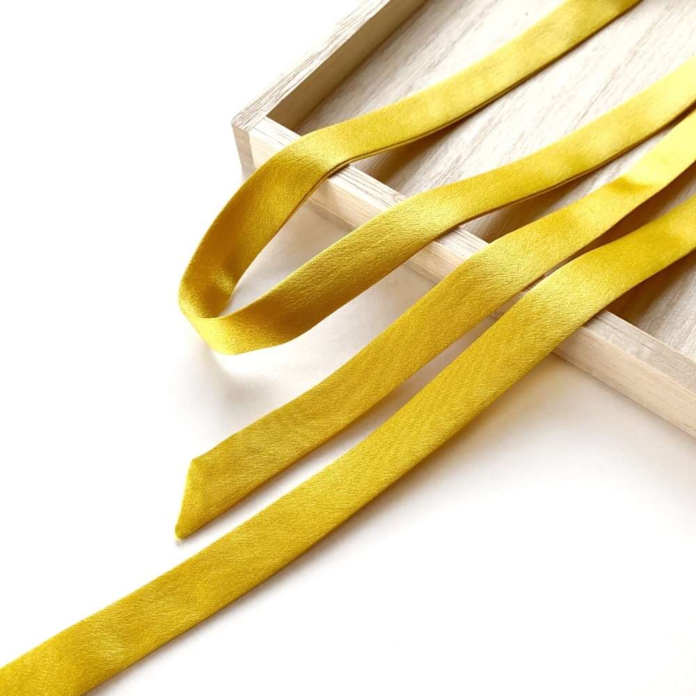 Golden Yellow mulberry silk satin ribbon  scarf on a white background
