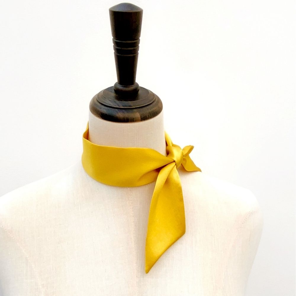 yellow gold mulberry silk satin skinny scarf tied around mannequin's neck