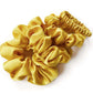 yellow silk scrunchies and hair tie on a white background
