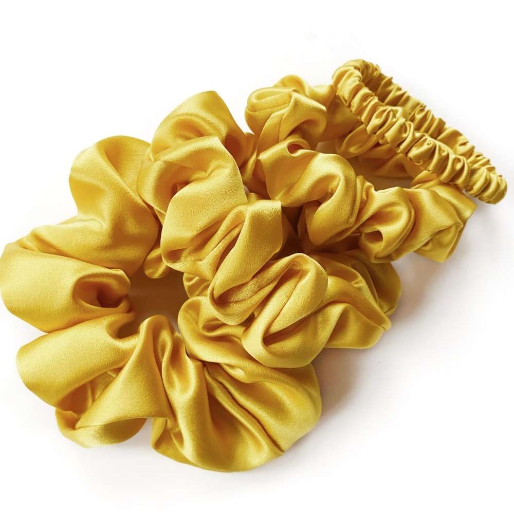yellow silk scrunchies and hair tie on a white background
