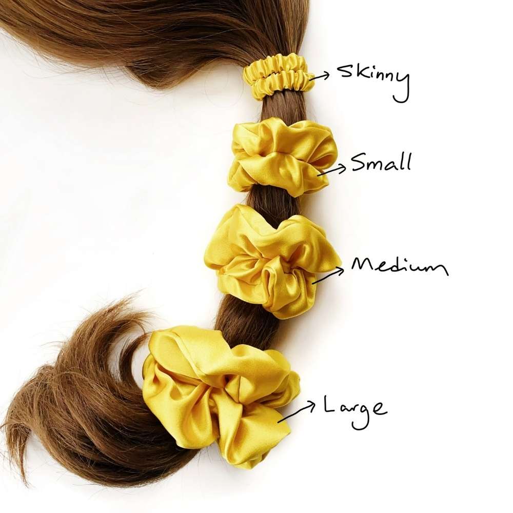 Yellow silk scrunchies of different sizes on a ponytail with labels.